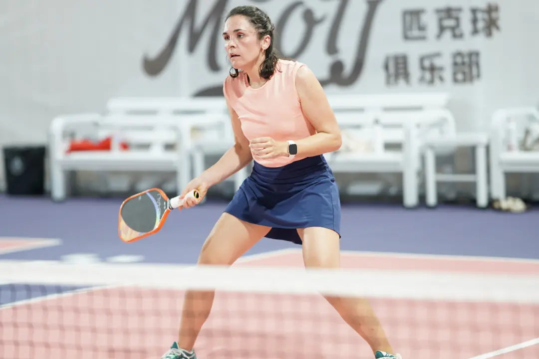 A pickleball player hitting a disguised offensive lob on the court.